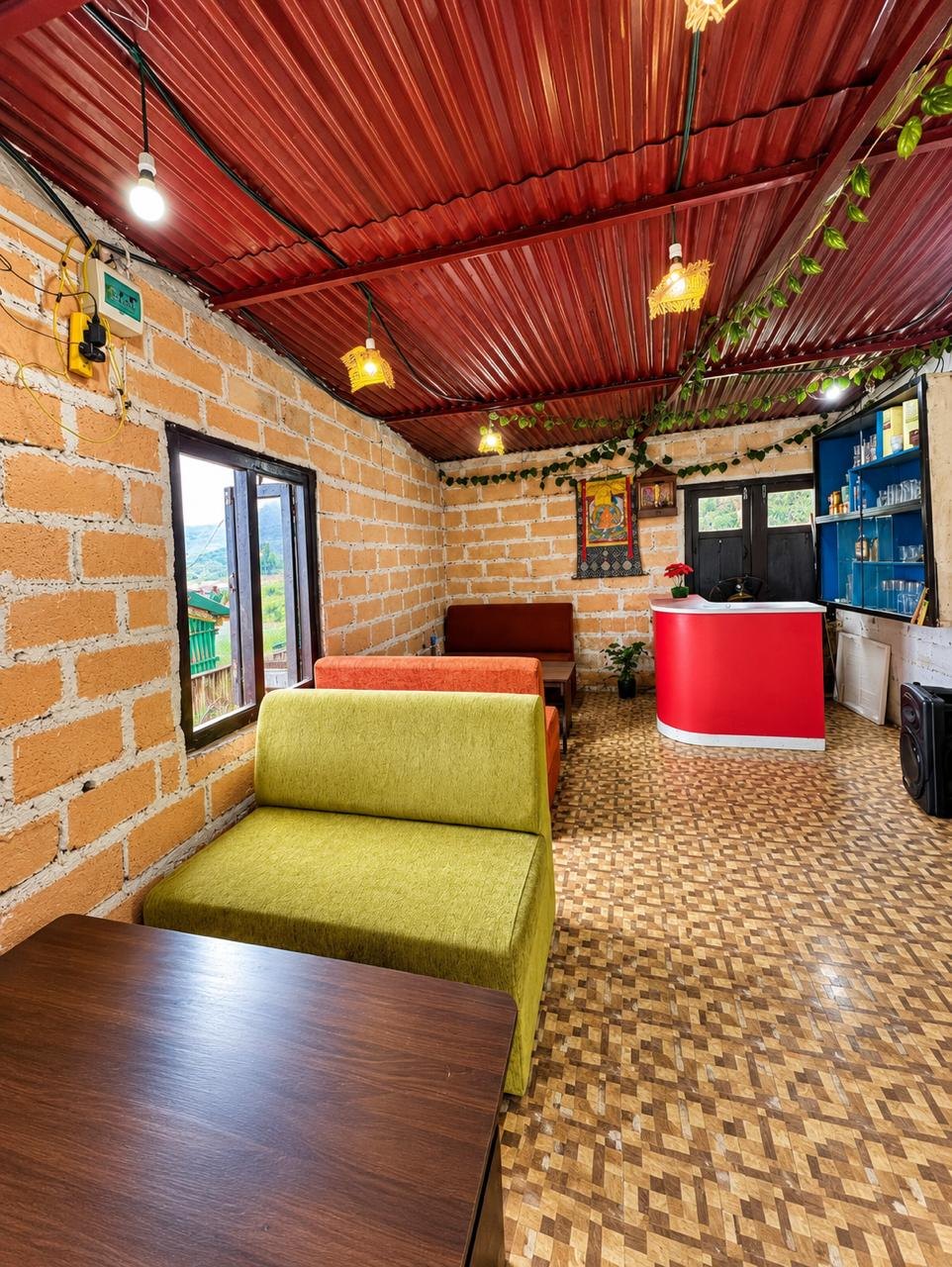 The indoor room with brick walls, sofas and the bar counter